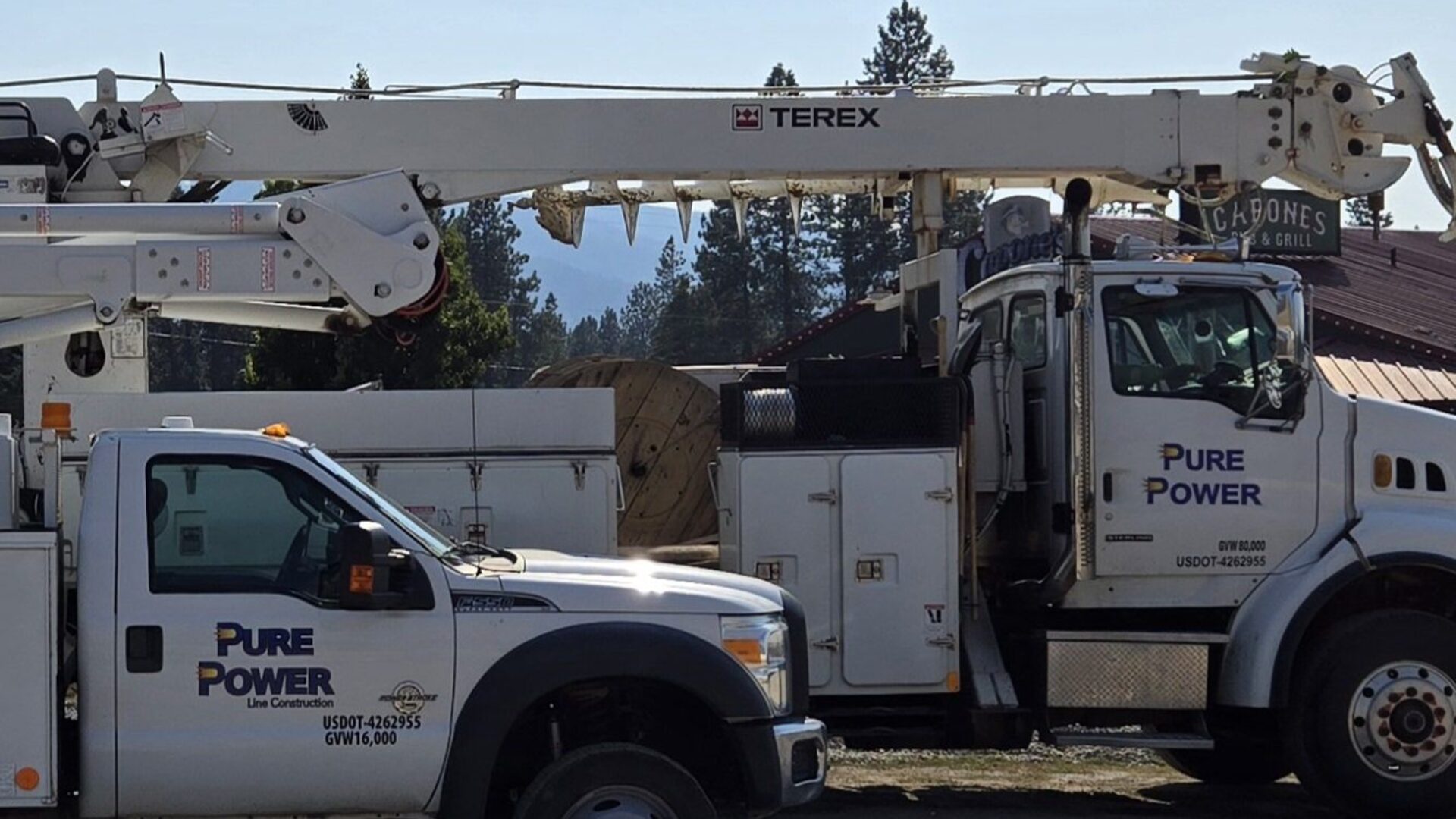 Branded Pure Power Line Construction service trucks staged in North Idaho